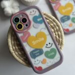 قاب موبایل آیفون لبخند قلبی محافظ لنزدار + بندست