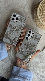 قاب موبایل ( آیفون - سامسونگ ) پروانه آموره نگین دار برجسته شاینی + بندست - Image 4