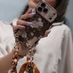 قاب موبایل آیفون گل فلاور کرم فندقی + بند ست اسکارف زنجیری